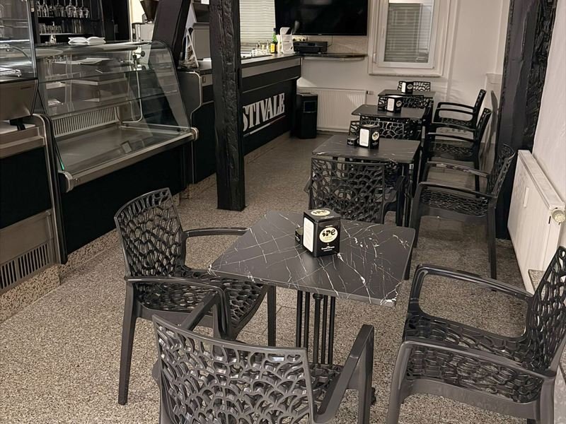 Der hintere Gastraum: links die gekühlte Glasvitrine, dahinter die Theke mit dem Schriftzug Stivale, davor Bistrotische zwischen dunklen Fachwerkbalken.